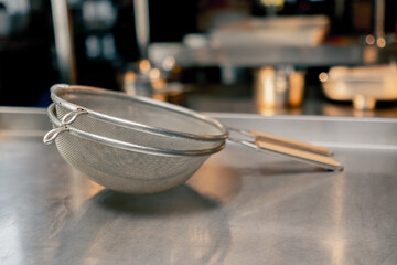 In the restaurant’s kitchen there are cook’s metal basins the shelf washed