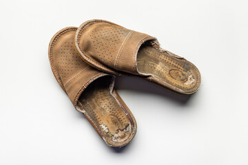 Men's brown suede slippers, very old. Studio shot.