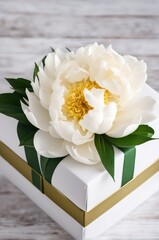 White Peony and Gift Box on Wooden Table