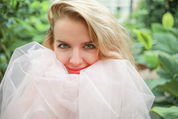 Close portrait of a girl with a smile and a white tulle skirt. Happiness concept