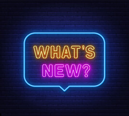 Obraz premium What s New neon sign in the speech bubble on brick wall background.