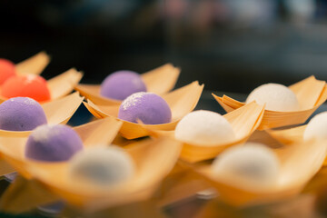 close-up on the shop window there are Japanese buns of different colors craft paper