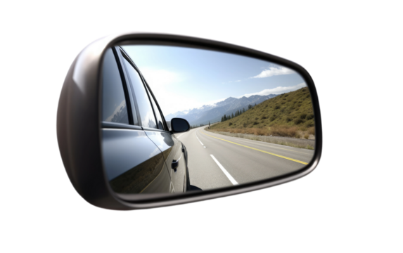 Car Side View Mirror Reflecting Mountains. A cars side view mirror reflecting the majestic mountains in its reflection.
