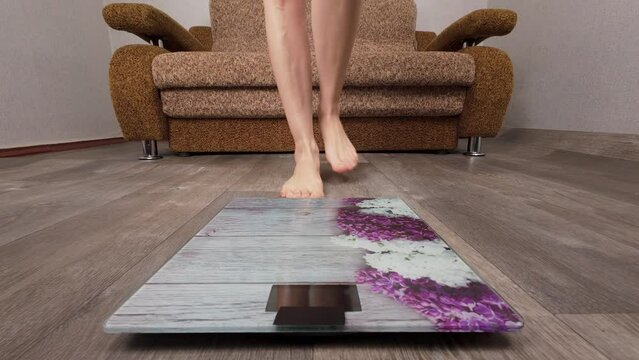 Women on scales measure weight close up. Female checking barefoot body overweight. Fitness diet young person. Healthy diet concept, woman feet standing on scales weight measure backgrounds lost weight