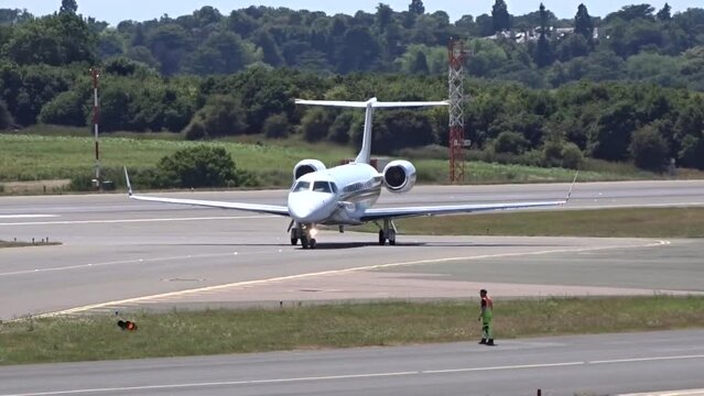 Generic Airplane Turning and Taxiing on the tarmac of airport unmarked white