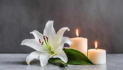 Fototapeta na wymiar funeral white lily and burning candles on grey background banner design