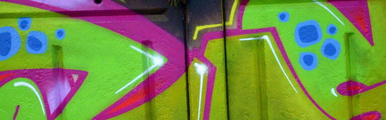 Colorful background of graffiti painting artwork with bright aerosol outlines on wall. Old school...