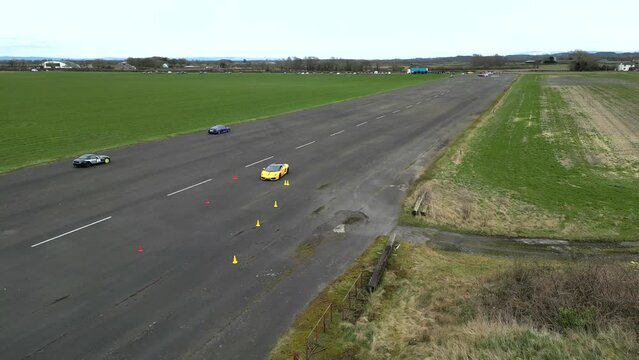 Supercars Trackday on Runway Airport Sports Car Exotics driving Drone aerial Dynamic shot