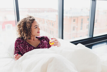 Woman on Hotel Bed Covering Self With Sheet.