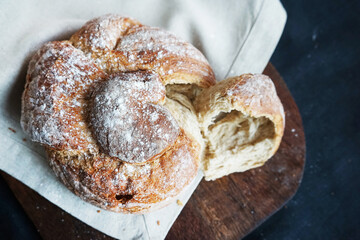 Fresh bread on a linen towel on a dark background