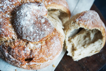 Fresh bread on a linen towel on a dark background