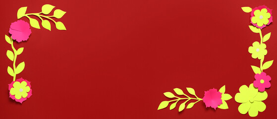 Frame made of paper flowers and leaves on red background