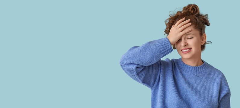 Young woman feeling awkward on light blue background with space for text
