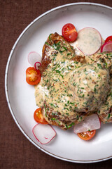 Juicy Chicken Fricassee with Creamy White Sauce and Fresh Vegetables on Plate