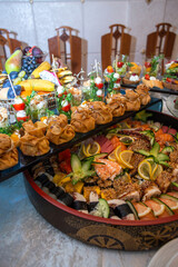 Delectable buffet spread of seafood, sushi, salads, fruit, and pastries.