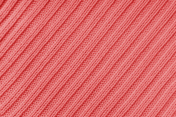 Jersey textile background , red diagonal striped knitted fabric. Woolen knitwear, sweater, pullover...