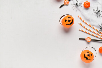 Composition with different drinking straws, pumpkins, spiders and web for Halloween celebration on light background