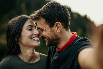 Fototapeta premium Multicultural pair shares a moment of happiness in a selfie
