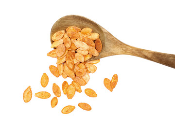 Pile roasted pumpkin seeds with salt in wooden spoon isolated on white