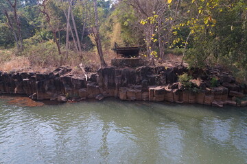 Fototapeta na wymiar A large stream full of rocks and broken bridges