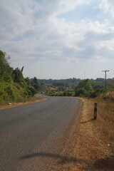 Lao Village, damaged paved road with beautiful mountain views