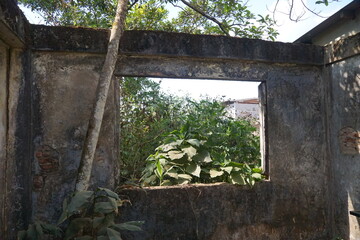 Ruins of an old house with a through passage. Destruction.