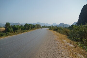 The route of the damaged road is mixed with a dirt road with views of forests and mountains on both...