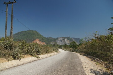 The route of the damaged road is mixed with a dirt road with views of forests and mountains on both...