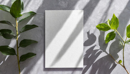 vertical sheets of textured white paper against a soft gray table background. the natural light creates subtle shadows from an exotic plant, enhancing the mockup overlay in a horizontal - obrazy, fototapety, plakaty
