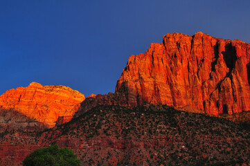 Fiery sunset on The Watchman and neighboring peaks from Springdale, Zion National Park, Utah,...