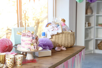 Fototapeta na wymiar Cake for baby shower party on table in room