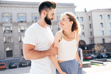 Smiling beautiful woman and her handsome boyfriend. Woman in casual summer clothes. Happy cheerful family. Female having fun. Couple posing in street at sunny day. Having tender moments