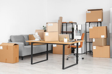 Interior of warehouse store with parcels and workplace