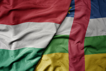 Obraz premium big waving national colorful flag of central african republic and national flag of hungary .