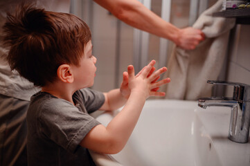 Young Child Reaching Out for Towel After Washing Hands