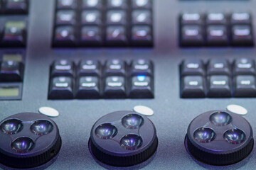 Audio mixing console, closeup of buttons and sliders in studio