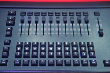 Sound mixer control panel, closeup of audio mixing console in nightclub