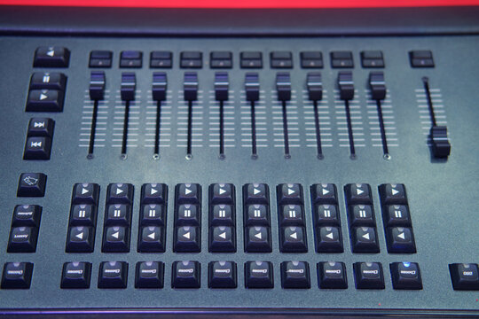Sound mixer control panel, closeup of audio mixing console in nightclub