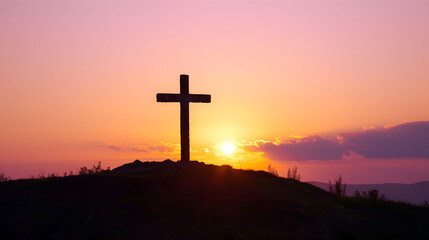 Cross Silhouetted on Hilltop at Sunset