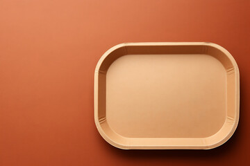 Plastic food containers with spoon and fork on a brown background.