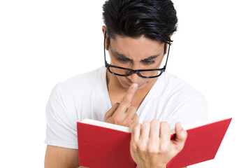 Closeup of a young man in glasses reading a book  - 736107796