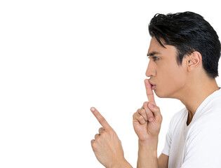 Side profile of a young handsome man giving Shhhh quiet, silence, secret gesture isolated on white...