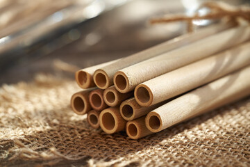 Bamboo drinking straws on a table - zero-waste concept - obrazy, fototapety, plakaty