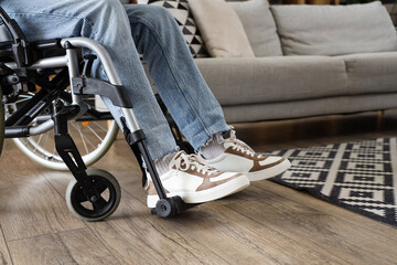 Young man in wheelchair at home, closeup