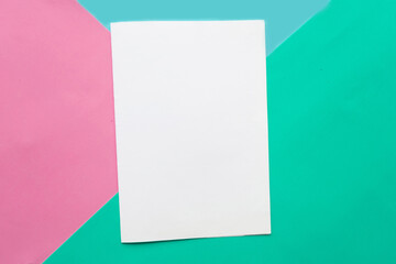 White mockup blank on geometric pink,blue and green paper background texture