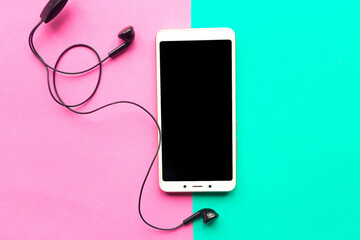 Mockup mobile and headphones on geometric color background. Minimal concept