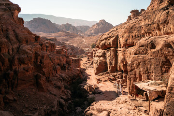 An Arabic path on a hill in the ancient Jordanian city of Petra looking down on the valley and...