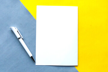 White mockup blank and pen on geometric grey and yellow background. Minimal concept