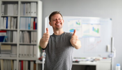 Happy guy stands in office and shows ok gesture. Lot things to do at home. Complete social...