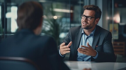 Smart businessman professional man in suit executive gesturing and talking in meeting with interview employee about work in modern office. copy space for text. - Powered by Adobe